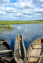 Obraz premium wooden fishing boats on the edge of water-meadow