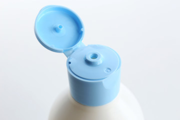 Open cosmetic bottle isolated on white