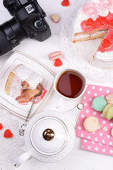 Different sweets and photo camera on table top view