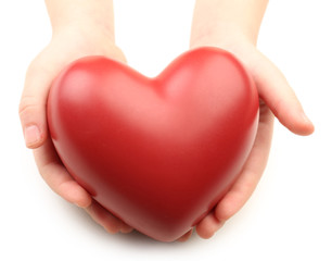 Fototapeta premium Heart in child hands isolated on white