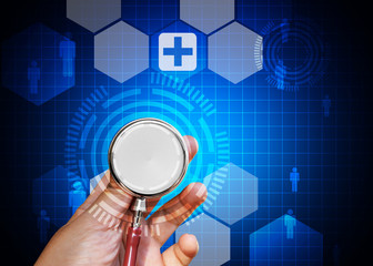 Doctor hand holding stethoscope on blue medical background