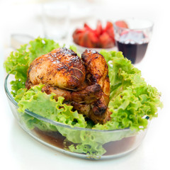 Whole roasted chicken with green salad and glass of vine
