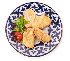 A pile of chicken nuggets on white plate with sauce