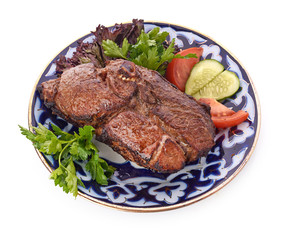 Meat on a grill with vegetables