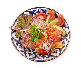 Meat on a grill with vegetables