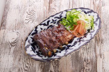 Meat on a grill with vegetables