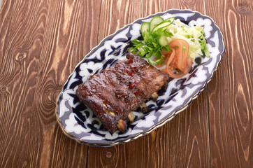 Meat on a grill with vegetables