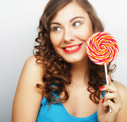Funny curly woman  holding big lollipop.