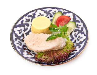 Meat on a grill with vegetables