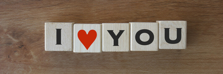 Wood Blocks with the words "I ♥ YOU" on wooden background.