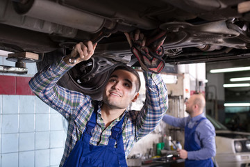 mechanics fixing car