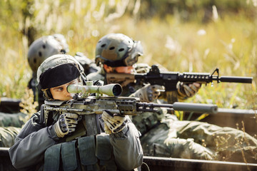 soldiers shoot at a target from the weapon