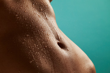 Fototapeta premium Beautiful woman's body with drops of water