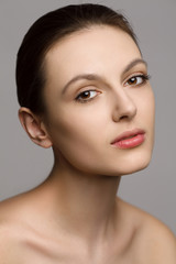 Fototapeta premium Portrait of a beautiful young woman with natural makeup