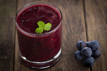 Glass of Grape Juice smoothie on wooden background