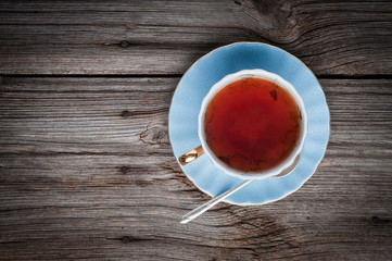 Cup of tea on a wooden background top view
