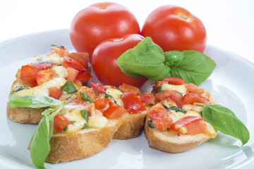 Fototapeta na wymiar italian bruschetta with tomato and basil