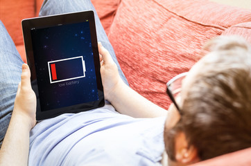 man with low battery tablet