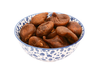 Whole dried figs in a blue and white china bowl