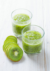 kiwi smoothie in a glass on wooden surface