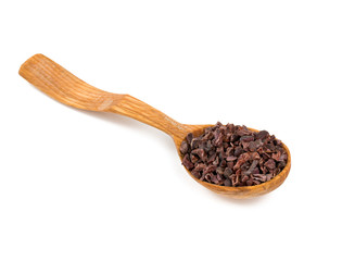 cocoa nibs in a wooden spoon