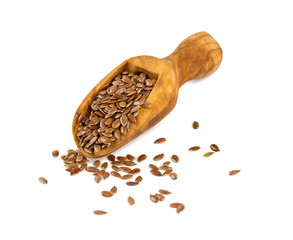 flax seed in a wooden scoop isolated on white