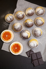Hot homemade chocolate muffins just from oven on baking paper