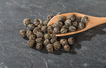 Dry tea leaves in wooden spoons