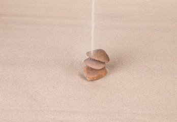 Sandy stream flows on a stack of stones.