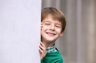 Portrait of a boy on a background of a wall