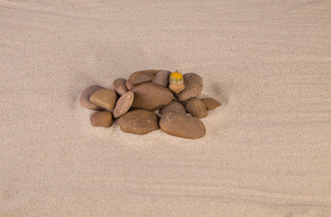 Fototapeta na wymiar Heap of rocks on the sand.