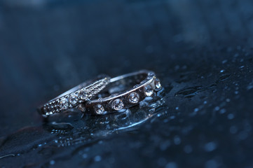 two wedding rings on a blue background