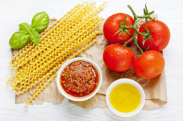 Italian cooking ingredients, pasta, beef stew sauce, fresh tomat