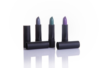 Lipsticks in gray, green and purple colors