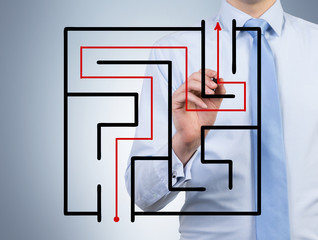 businessman drawing maze