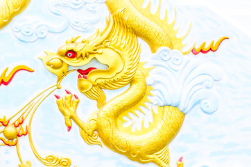 Obraz premium golden dragon on the wall of temple,thailand