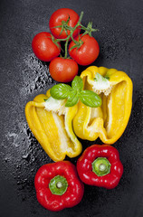 ripe tomatoes, yellow and red sweet pepper and fresh basil on a