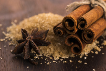 Cinnamon sticks with pure cane brown sugar on wood background