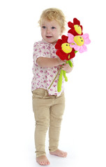 two year little girl with flowers in their hands.