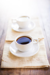 Two cups of coffee on brown napkin