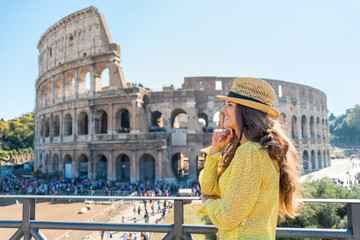 Fototapeta na wymiar Portrait of thoughtful young woman in front of colosseum in rome