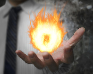 Burning fire ball in man's hand
