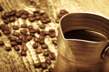 Coffee turk and coffee beans on old gray wooden table. Toned