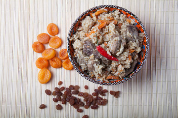 Pilaf  in Turkish bowl with dried apricots and raisins