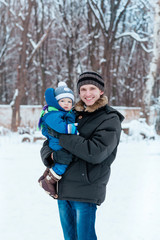 Fototapeta na wymiar Happy father and baby playing on snow