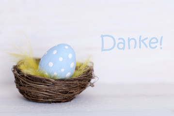 One Blue Easter Egg In Nest With German Danke Means Thank You