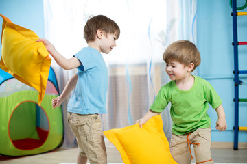 kids boys  playing with pillows