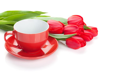 Fototapeta na wymiar Fresh red tulips with coffee cup