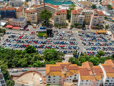 parking area full of cars beneath the mountain in gibraltar