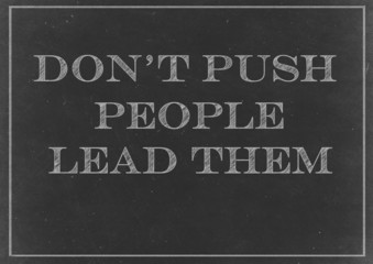 Fototapeta premium Chalkboard with Don't Push People, Lead Them message Hand Drawn